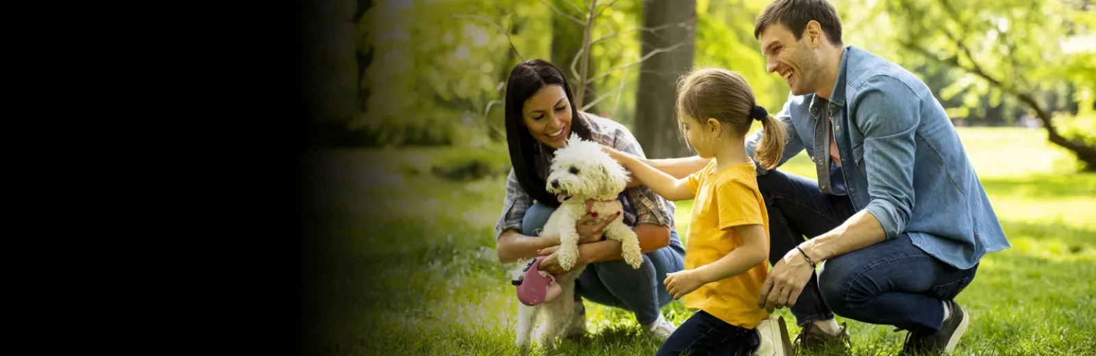 Family playing with dog outside